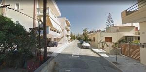 a car driving down a street between two buildings at Sitzanaki Home in Chania