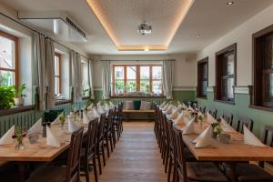a row of tables in a room with chairs at Hotel Drei Tannen in Moosburg +8 photos