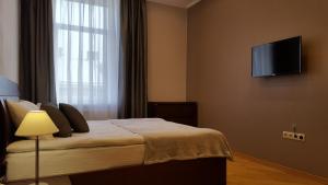 Televízia a/alebo spoločenská miestnosť v ubytovaní Soprano Apartment Tamanska