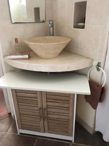 a bathroom with a bowl sink on a counter at La Laiterie du Logis in Chaniers