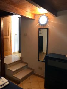 a bathroom with stairs and a mirror on the wall at La Casetta di Ninetta in Ustica