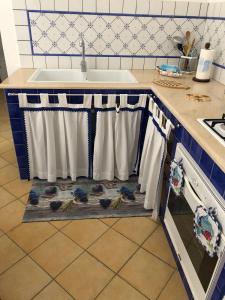 a kitchen with a sink and towels on a counter at La Casetta di Ninetta in Ustica