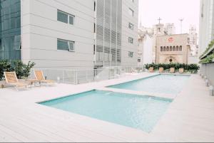 a swimming pool on the side of a building at Studio 5 Stars Bellini in Buenos Aires