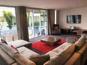 a living room with a couch and a coffee table at Waimahana Apartment 4 in Taupo