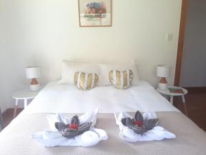 A bed or beds in a room at Magic Cottages at Takou River