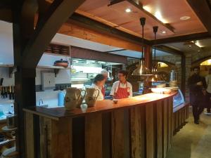 two people standing at a counter in a kitchen at Bridgefield Guest House in Margaret River Town