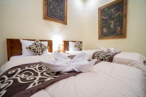 Postel nebo postele na pokoji v ubytování Omank Agus Homestay