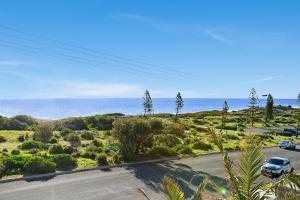 a car parked on a road near the ocean at Ocean View Moana - C21 SouthCoast Holidays in Moana