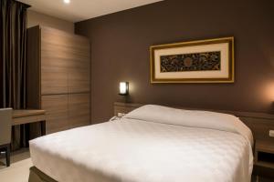 Letto o letti in una camera di Mambruk Hotel & Convention
