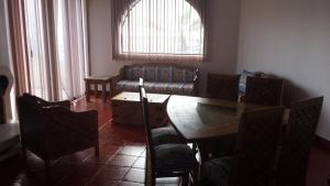 a living room with a dining room table and chairs at Bungalos Las Esperanzas in Cabo Punta Banda