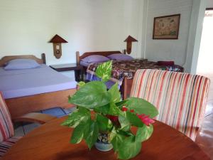 Un pat sau paturi într-o cameră la Rini hotel