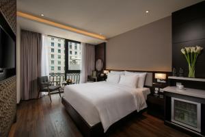 una camera d'albergo con letto e camino di Grandiose Hotel & Spa a Hanoi