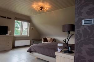 a bedroom with a bed and a ceiling at B&B Welcome Home in Laakdal