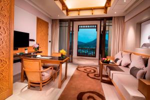 a living room with a couch and a table at Banyan Tree Hotel Huangshan-The Ancient Charm of Huizhou, a Paradise in Huangshan