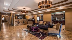 a lobby of a hotel with couches and a bar at Best Western Manhattan Inn in Manhattan
