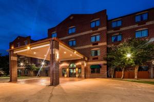 a large brick building with a large driveway at Best Western Plus The Woodlands in The Woodlands
