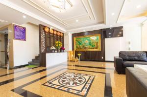 a lobby with a couch and a painting on the wall at Biển Ngọc Hotel in Vung Tau