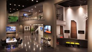 a lobby of a building with a tv on the wall at Vīb Best Western Springfield in Springfield