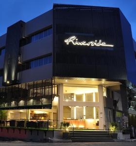 a building with a sign on the front of it at Riverside Boutique Hotel in Kuantan