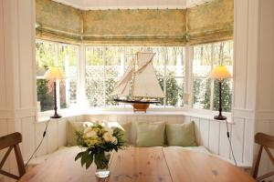 Das Gut klein Bollhagen في Wittenbeck: غرفة معيشة مع طاولة وقارب في نافذة