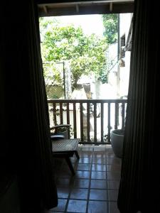 a view of a porch with a bench on a balcony at Secret Palace Guest house in Galle