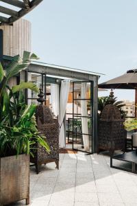 a patio with two chairs and an umbrella at Claris Hotel & Spa GL, a Small Luxury Hotel of the World in Barcelona