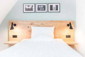 Postel nebo postele na pokoji v ubytování Ulmer Münster Hotel