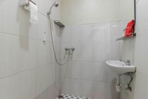 a bathroom with a sink and a shower at RedDoorz Plus near Lippo Cikarang Mall in Bekasi