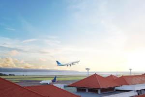 an airplane is taking off from an airport runway at Novotel Bali Ngurah Rai Airport in Kuta