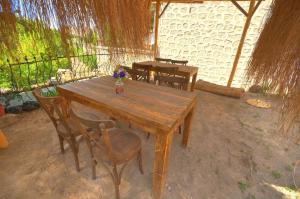 a wooden table and chairs in a room at Belisırma Cave Pansiyon in Aksaray +41 photos