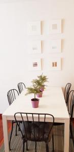 a white table with chairs and plants on it at Vivienda Turística Pirineos XXI in Canfranc-Estación