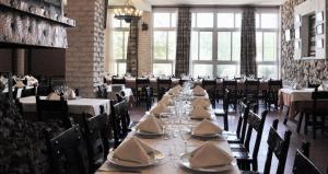 a dining room with a long table with dishes on it at La Fuensanta Hostal-Rural in Horche