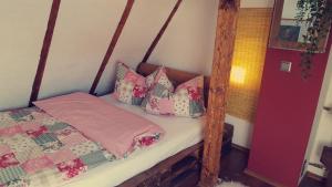 a bedroom with a bed with a wooden frame and pillows at uebernachtung unna in Unna