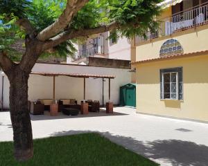 a building with a tree in front of it at B&B Numero5 in Castellammare di Stabia