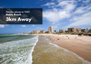 a view of a beach with people in the water at Faith, Hope & Love Self Catering in Port Elizabeth