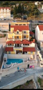 an aerial view of a building with a swimming pool at Apartments Sunset in Mlini