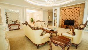 a living room with two chairs and a tv at Muong Thanh Luxury Phu Tho in Việt Trì