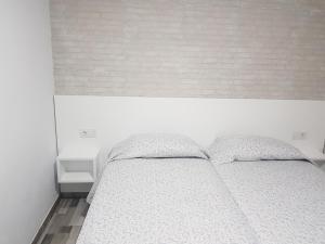 A bed or beds in a room at Apartamento muelle