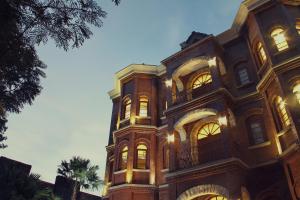 a large brick building with lights on at Jacatra Homestay in Malang