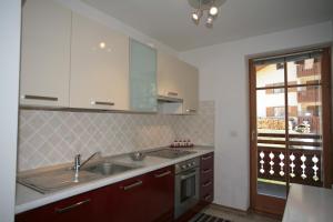 a kitchen with a sink and a counter top at Villetta ai Pini Deluxe in Canazei