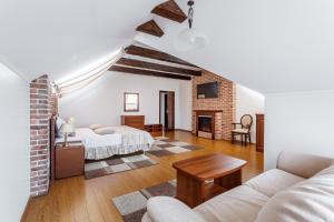 a living room with two beds and a couch at Hotel Yuzhnaya Bashnya in Krasnodar