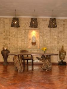 a dining room with a wooden table and some lights at The Aberdare Country Club in Mweiga