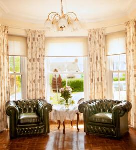 a living room filled with furniture and a window at Burford Lodge Guest House in Ardglass