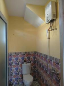 a bathroom with a toilet and a shower at Runia Lembang in Bandung