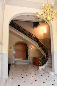 a staircase in a building with a chandelier at Passeig De Gràcia Luxury in Barcelona