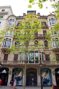 a large building with people walking in front of it at Passeig De Gràcia Luxury in Barcelona