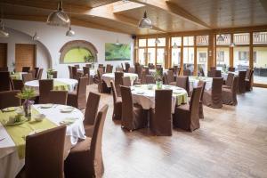 a dining room with tables and chairs in a building at OG's Golf Lodge in Kematen an der Krems