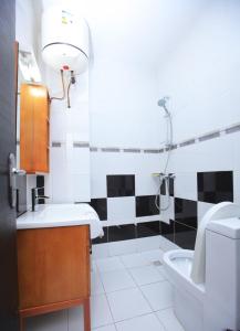 a bathroom with a sink and a toilet at Enka Flat Hotel in Abidjan