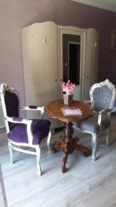 a dining room with a table and two chairs at Au Doubs Cocon Fleuri in Mamirolle