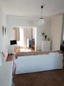 a white living room with a couch and a table at Lethes View Apartamentos Turisticos in Ponte da Barca